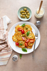 Vegan potatoes fritters with tomatoes top view food