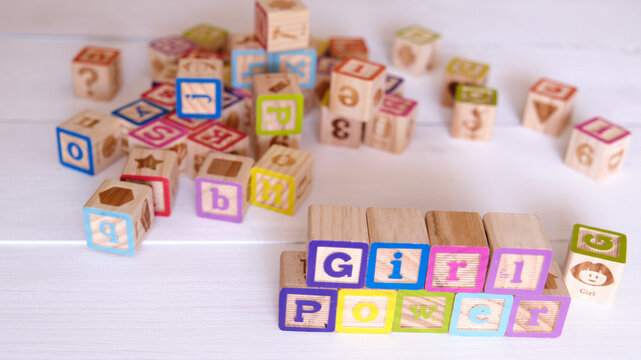 Word Girl Power written on wood block with colored letters.
