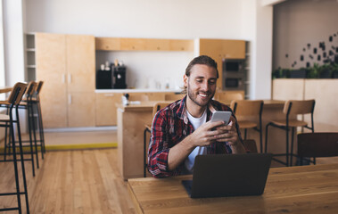 Millennial businessman working at desk in office