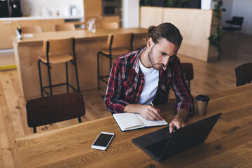 Millennial businessman working at desk in office