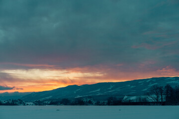 Fototapeta na wymiar sunrise above the Totenåsen Hills, Norway, in winter, seen from the rural lowlands