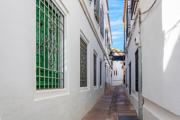 A very narrow alley or road through the historic Jewish Quarter or Juderia of the Spanish city of Cordobay, Spain, in the Andalusian southern region.