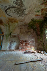The wall of the arch of the old destroyed and abandoned Orthodox church in Russia. A recess in the wall. Red old brick, peeling paint.
