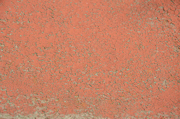 Selective focus old brown cracked paint. The texture of the old rusty paint with cracks. Dried in the sun and cracked color on the wall of country house. Peeling coating.