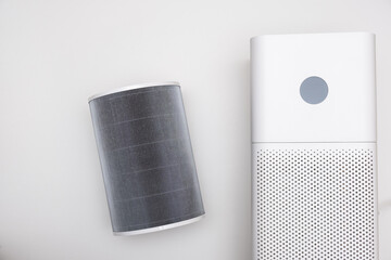Indoor air purifier of white color close-up on a white background. Dust and allergy cleaner in the...