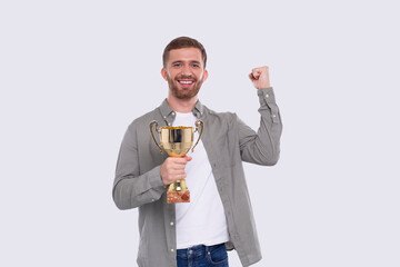 Man Very Happy and Excited, Raising arms, Celebrating a Victory or Success Holding Trophy. Winner Sign. an Isolated with Trophy in Hands. Looking to Camera