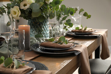 Festive table setting with beautiful floral decor indoors