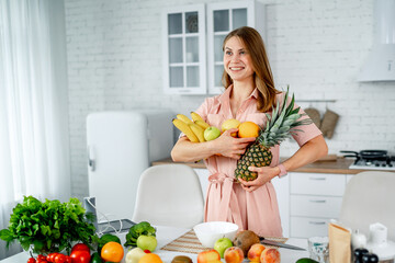 Beautiful woman with vegeterian food. Attractive young female holding tasty vegetables.