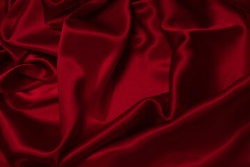 Rich and luxury red silk fabric texture background.