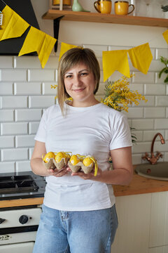 Woman 37 years old with Easter eggs in the kitchen