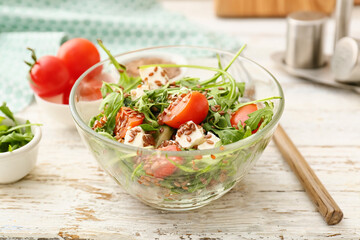 Bowl with tasty healthy vegetable salad on table