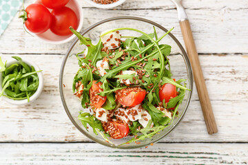 Bowl with tasty healthy vegetable salad on table