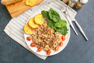 Plate with tasty breakfast on dark background