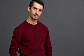 Obraz premium portrait man in a red sweater hand gesture posing self confidence isolated background
