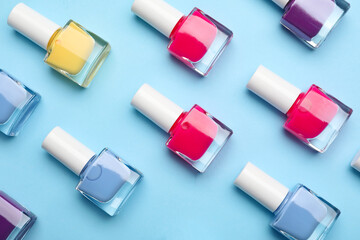 Set of nail polish bottles on color background