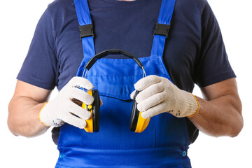 Male worker with protective ear muffs on white background