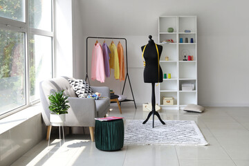 Interior of modern room with mannequin, rack and hoodies