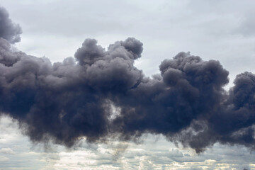 dangerous cloud of black smoke close up as background