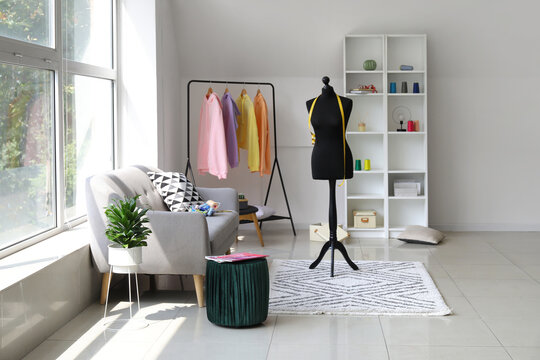 Interior of modern room with mannequin, rack and hoodies