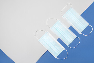 Surgical masks on color background