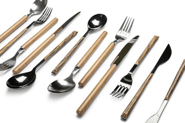 Fototapeta premium Set of stainless steel cutlery with wooden handles on white background