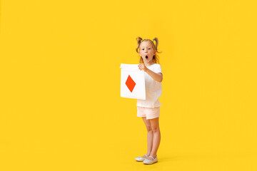 Adorable little girl with envelope on yellow background