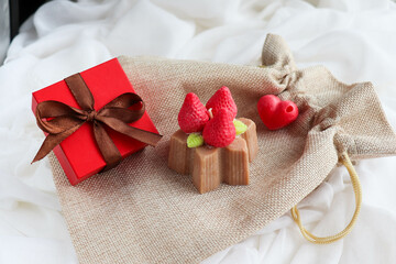 gift concept for valentine's day. handmade natural soy wax candle in the shape of a strawberry cake 