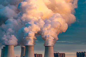 Smoking pipes of thermal power plant on sunset.