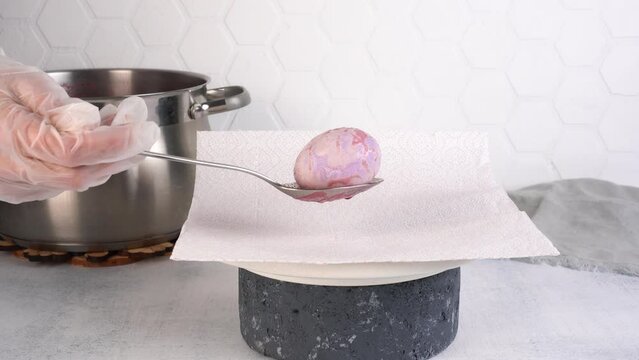 Coloring Easter eggs with carcade tea from hibiscus flowers. Egg becomes purple.