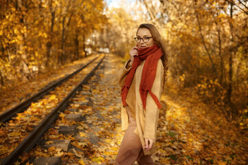Happy young woman under autumn sun light