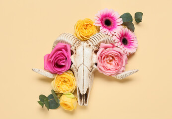 Skull of sheep with flowers on color background