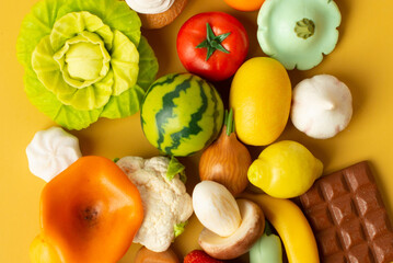 vegetables, fruits and sweets from polymer clay on a yellow background