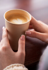 woman holding cup of coffee
