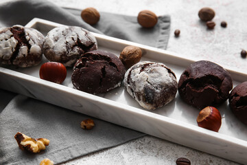 Board of chocolate brownie cookies on light background, closeup