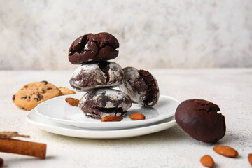 Plates of chocolate brownie cookies on light background