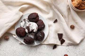 Plate of chocolate brownie cookies on light background
