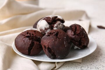 Plate of chocolate brownie cookies on light background