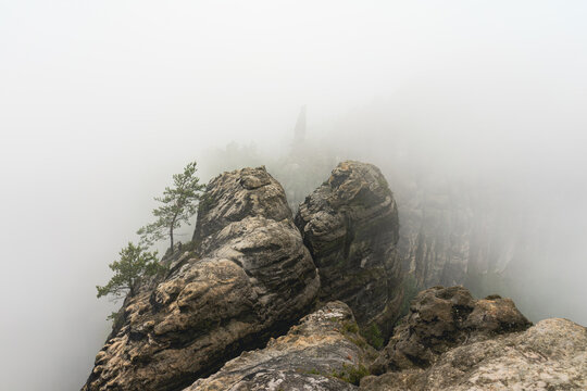 An early cloudy morning in mountain. Schrammsteine - group of rocks are a long, strung-out, very jagged in the Elbe Sandstone Mountains located in Saxon Switzerland in East Germany.