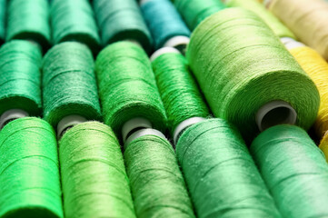 Closeup view of spools with green threads