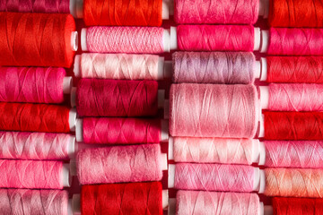 Spools with different sewing threads as background
