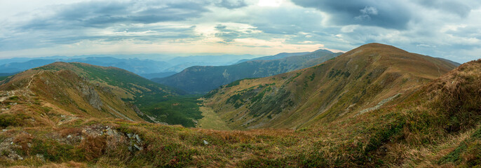 Fototapeta na wymiar Panoramic mountain landscape. Cloudy sky. Chornohora mountain range. Western Ukraine.