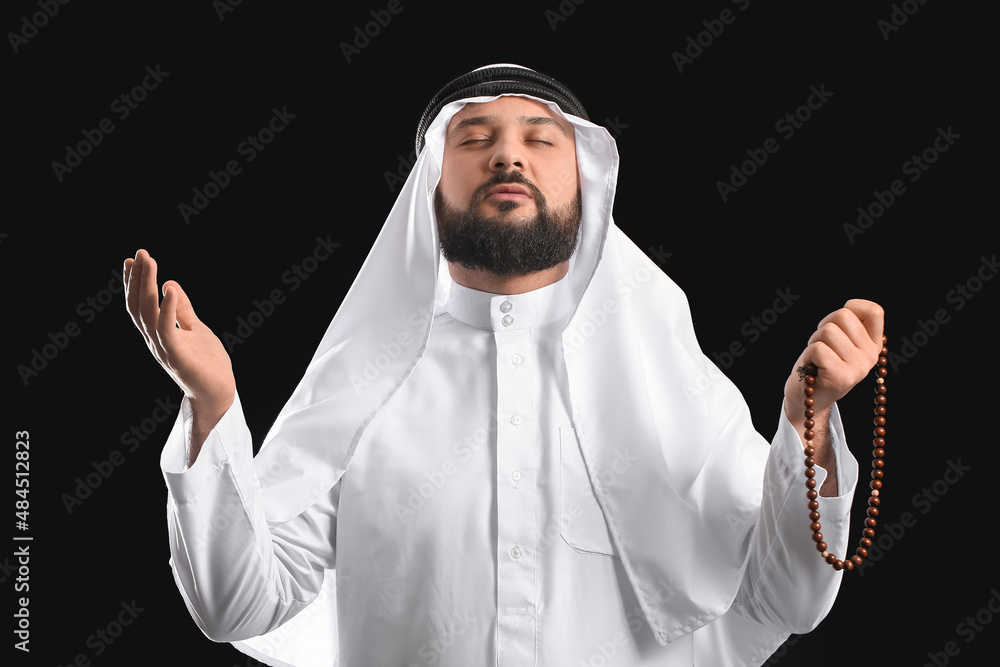 Wall mural muslim man praying on black background