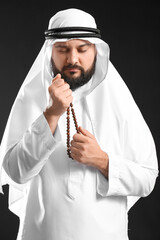 Muslim man praying on black background