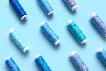 Thread spools on blue background