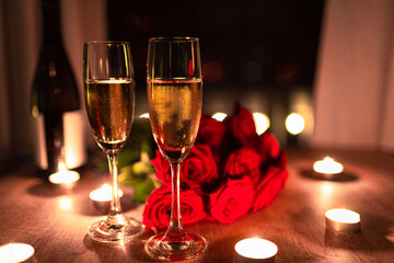 Red roses, candle lights and champagne glasses on table, valentines day background