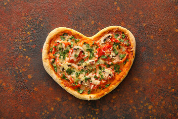 Tasty heart-shaped pizza on grunge background. Valentine's Day celebration