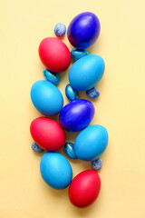 Different painted Easter eggs on light background