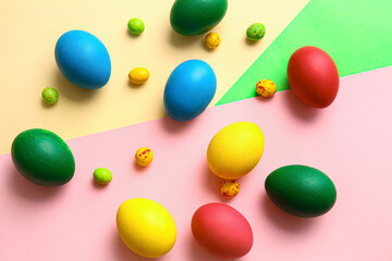 Different painted Easter eggs on color background