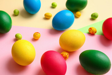 Different painted Easter eggs on color background