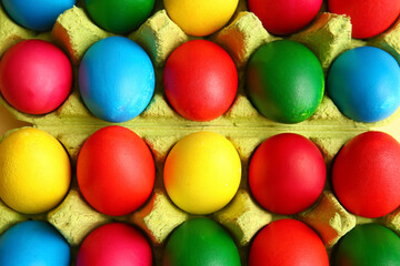 Fototapeta na wymiar Multicolored Easter eggs in holder, closeup